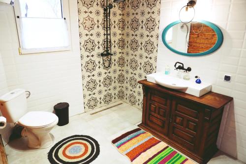 a bathroom with a sink and a toilet and a mirror at Agroturystyka Prynuka in Skroblaki