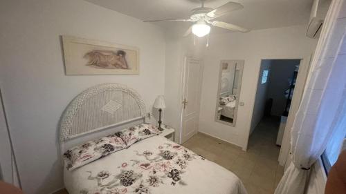 a bedroom with a bed and a ceiling fan at Sunny Florida in Torrevieja