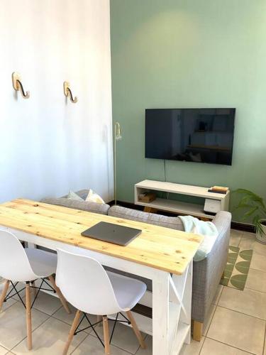 a living room with a table and a couch at Beachside Studio Apartment on Surfers Corner in Cape Town