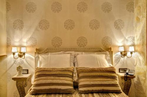 a bedroom with a bed with two pillows at Hotel Boutique Real Posada De Liena y Restaurante Liena in Murillo de Gállego