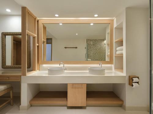 a bathroom with two sinks and a large mirror at Garrya Tongsai Bay Samui in Choeng Mon Beach