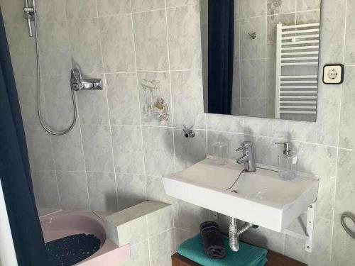 a bathroom with a sink and a pink toilet at Villa Antonia con piscina privada AC y wifi in Tarragona