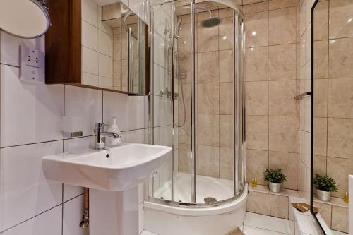 a bathroom with a sink and a shower at Whole house in Central Camden Town in London