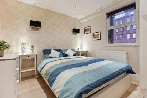 a bedroom with a large bed and a window at Whole house in Central Camden Town in London