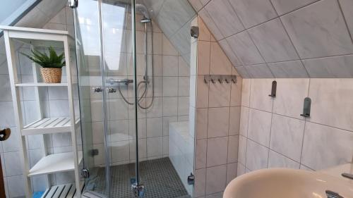 a bathroom with a shower and a sink at Appartement im Silwai 4 in Westerland