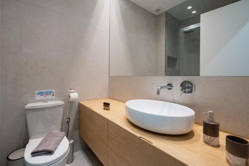 a bathroom with a white sink and a toilet at Lycabettus Residence in Athens