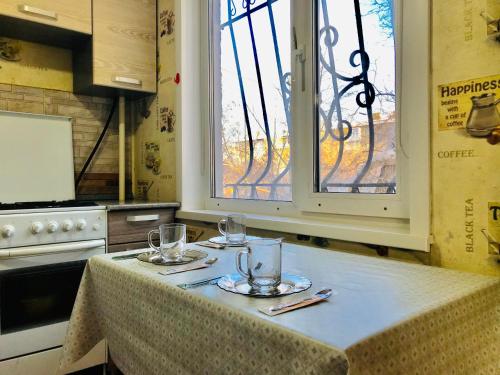 a kitchen with a table with wine glasses on it at Apartaments in the city center in Karagandy