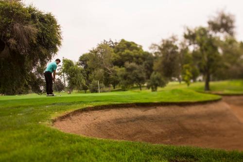 a man playing golf on a golf course at Homewood Suites by Hilton Santa Maria in Santa Maria