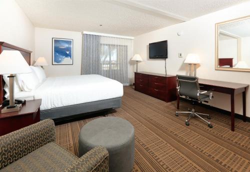 a hotel room with a bed and a desk and chair at Homewood Suites by Hilton Santa Maria in Santa Maria