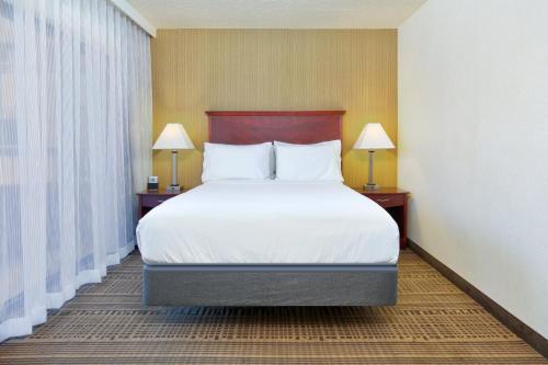 a bed in a hotel room with two lamps at Homewood Suites by Hilton Santa Maria in Santa Maria