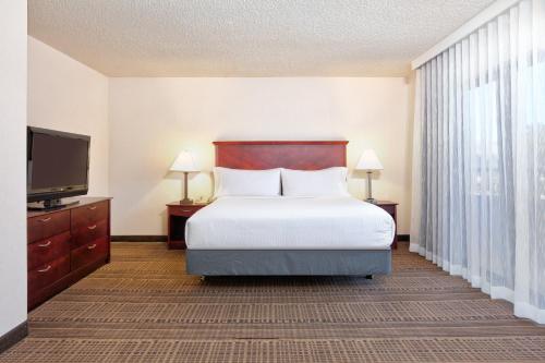 a bedroom with a bed and a flat screen tv at Homewood Suites by Hilton Santa Maria in Santa Maria