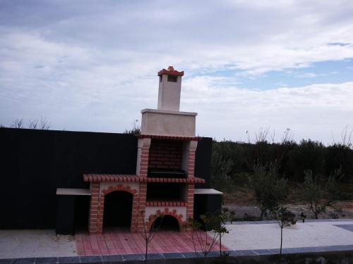 a brick fireplace with a lighthouse on top of it at Maison des Oliviers, Yasmine Hammamet, Bouficha in Hammamet Sud