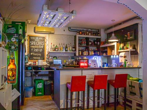 a bar with red bar stools in a restaurant at Whole Wide World Hostel in Zagreb