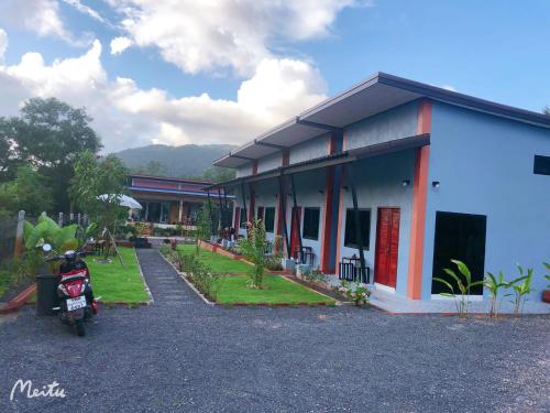 a building with a motorcycle parked in front of it at Villafarmsuk@khanom in Khanom
