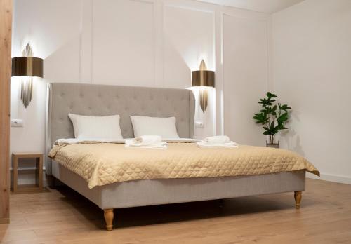 a bedroom with a bed with two towels on it at Coban Residence Apartments in Braşov