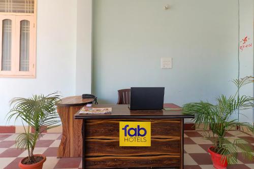 a desk with a laptop on top of it at FabExpress Buddha Residency in Patna