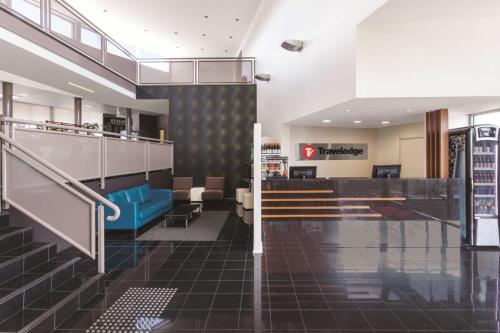 a lobby with a staircase and a waiting room at Travelodge Hotel Hobart Airport in Cambridge