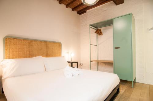 a bedroom with a white bed and a glass door at Umbrian Concierge - La Corte del Grillo in Perugia