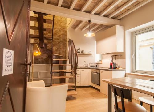 a kitchen and dining room with a table and chairs at La Corte del Grillo in Perugia