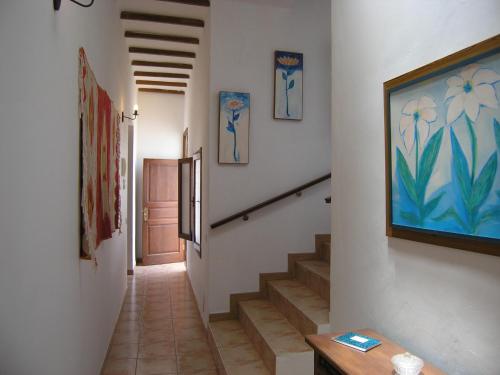 a hallway with stairs and paintings on the walls at Vivienda tradicional Canaria Saulo 3 in Agüimes