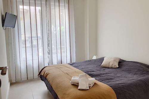 a bedroom with a bed with two towels on it at Sublime Apartment Center Croisette LIVE IN Moliere in Cannes