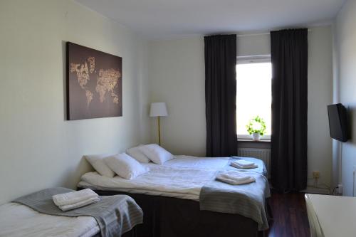 um quarto de hotel com duas camas e uma janela em Hotell Skinnargården em Malung