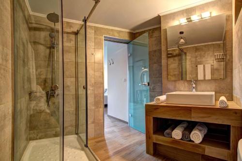 a bathroom with a sink and a shower at Villa Bougainvillea by Villa Plus in Marathias