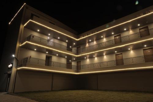 a building with lights on the side of it at The Presidential Suites in Bhuj