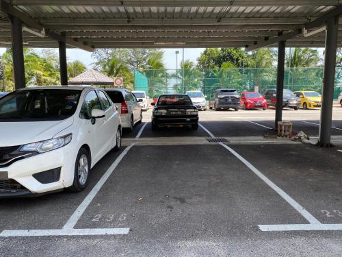 a group of cars parked in a parking lot at Desiran @ Timurbay - seafront studio apartment with WiFi in Kuantan