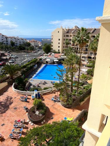 a view of a pool from the balcony of a hotel at Castle Harbour Home in Los Cristianos