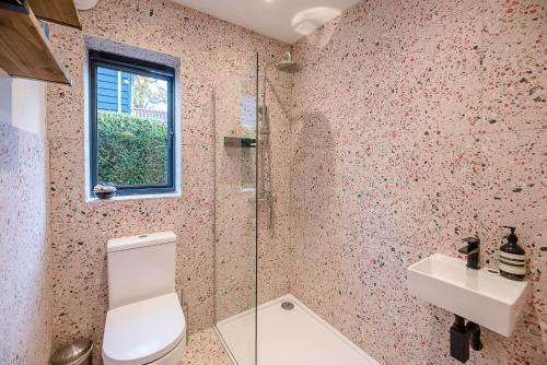 a bathroom with a toilet and a sink at Little Bramble, Orford in Orford