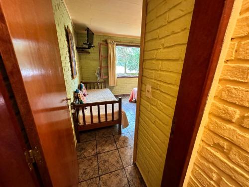 a hallway with a room with a crib and a table at La Posada De Gogg Apartamentos in Bella Vista