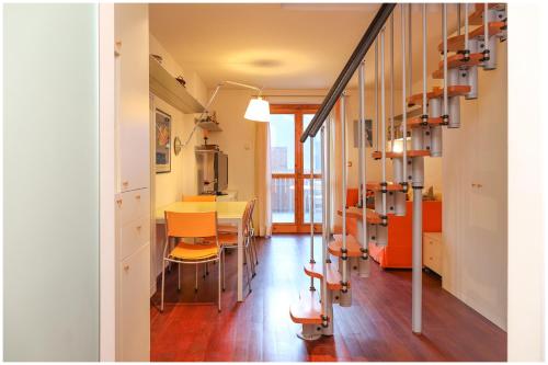 ein Zimmer mit einem Tisch, Stühlen und einer Treppe in der Unterkunft [Casa Quadrifoglio] a 3 minuti dalle piste da sci in Gressoney-Saint-Jean