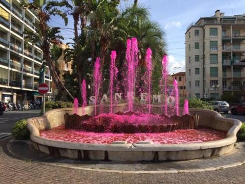 a pink fountain in the middle of a street at Alloggio U SPORTEGU DA E MONTI A GIAIA in Badalucco