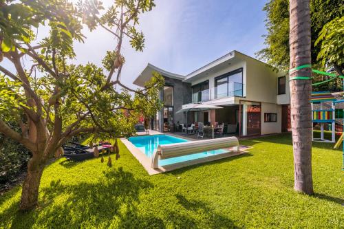 a house with a swimming pool in a yard at Villa das Quebradas by An Island Apart in Funchal