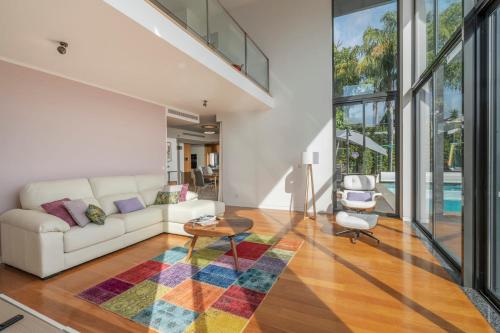 a living room with a white couch and a table at Villa das Quebradas by An Island Apart in Funchal