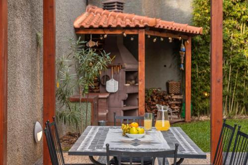 a table with a bowl of fruit on top at Villa das Quebradas by An Island Apart in Funchal