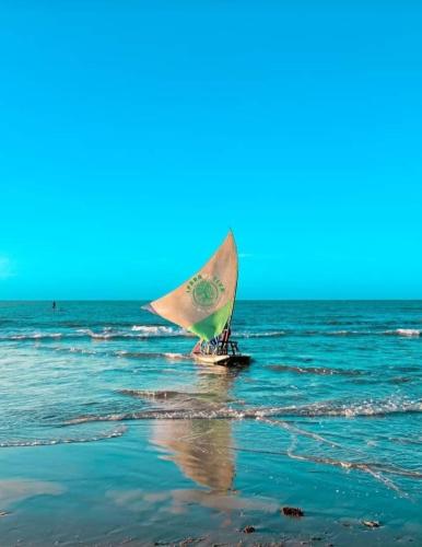 a person on a sail boat in the ocean at Barbanera Club & Hotel de Charme in Caucaia