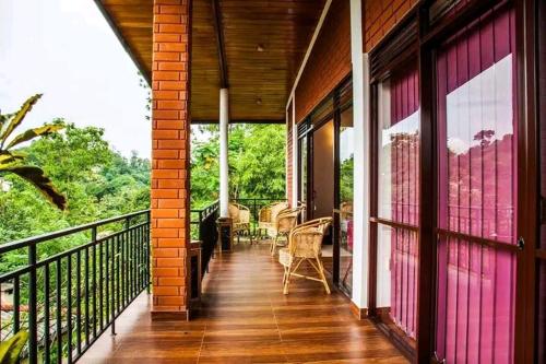 a porch of a house with a balcony at The Tenthola in Kandy