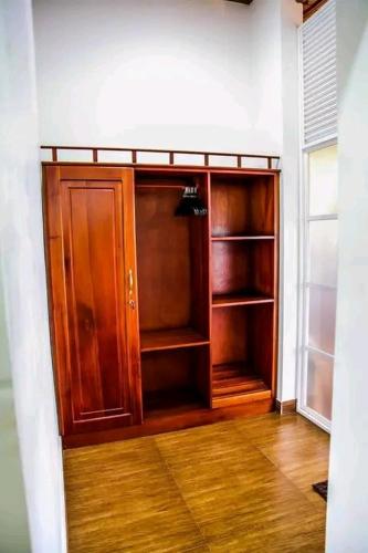 a room with a closet with wooden shelves in it at The Tenthola in Kandy