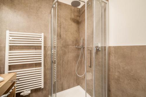 a shower with a glass door in a bathroom at Ferienwohnung Bergerr in Avelengo