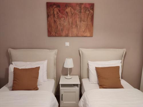 a bedroom with two beds and a lamp on a night stand at Central & Comfortable, 70m² Apt in Neos Kosmos in Athens