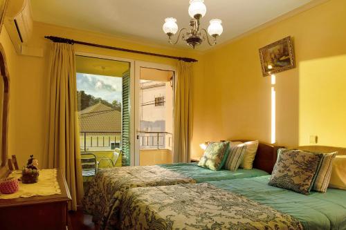 a bedroom with a bed in front of a window at Palheiro Residence Familiar 2 in Funchal