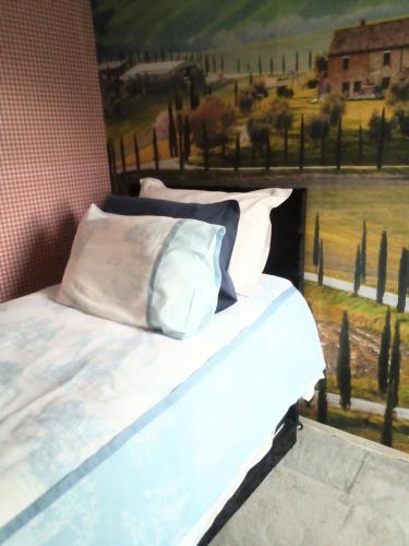 a bedroom with a bed with a painting on the wall at Homestay Cardiff in Cardiff