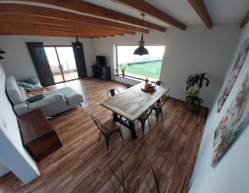 a living room with a wooden table and a couch at Casa Percea in Mazo