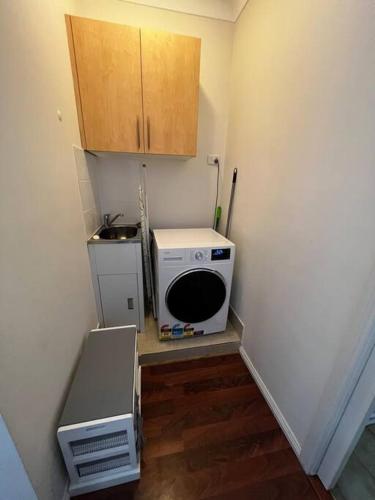 a small kitchen with a microwave and a stove at 2 bedroom retreat with Swimming Pool in Baulkham Hills