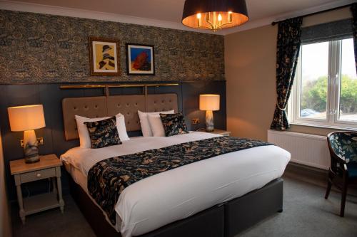 a bedroom with a large bed and a window at The Red Lion Inn by Chef & Brewer Collection in Todwick