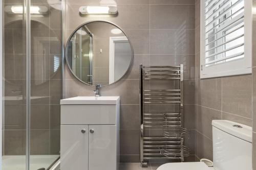 a bathroom with a sink and a mirror at Cottage Mews - Seaside Cottage Parking Terrace in Tenby