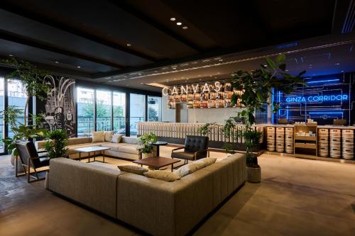 a lobby with couches and tables in a store at The Royal Park Canvas Ginza Corridor in Tokyo