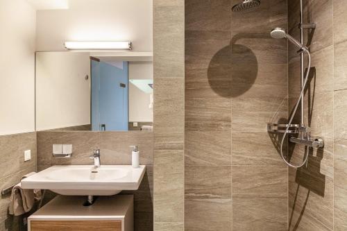 a bathroom with a sink and a shower at Apart-hochzillertal Gartenwohnung in Kaltenbach